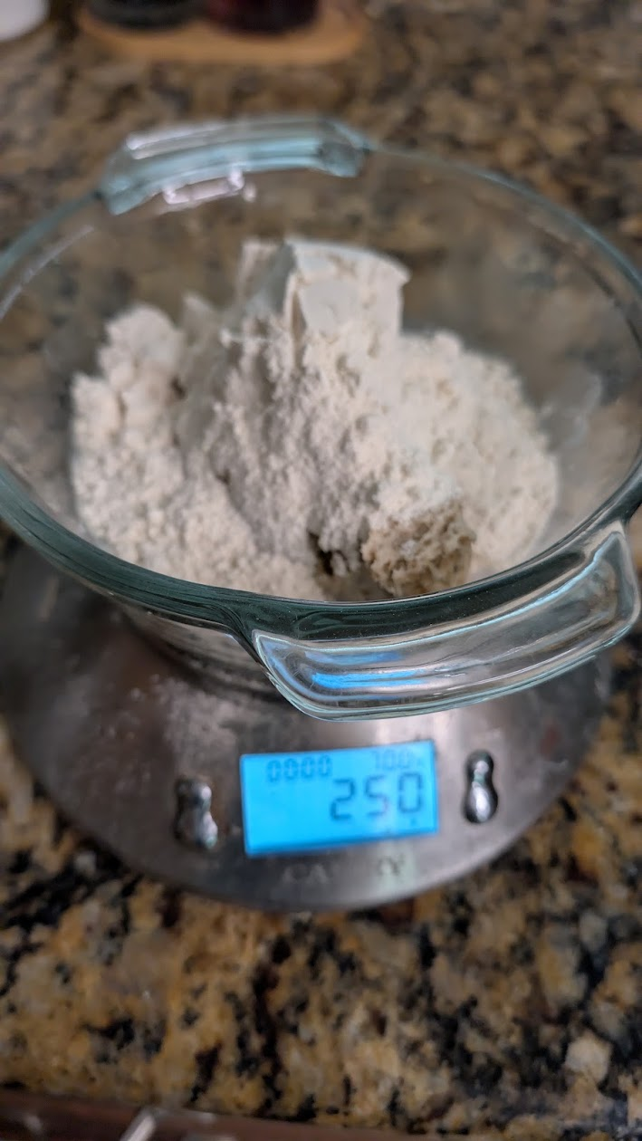 Digital scale reading 250g: 100g madre, 100g flour, 50g water