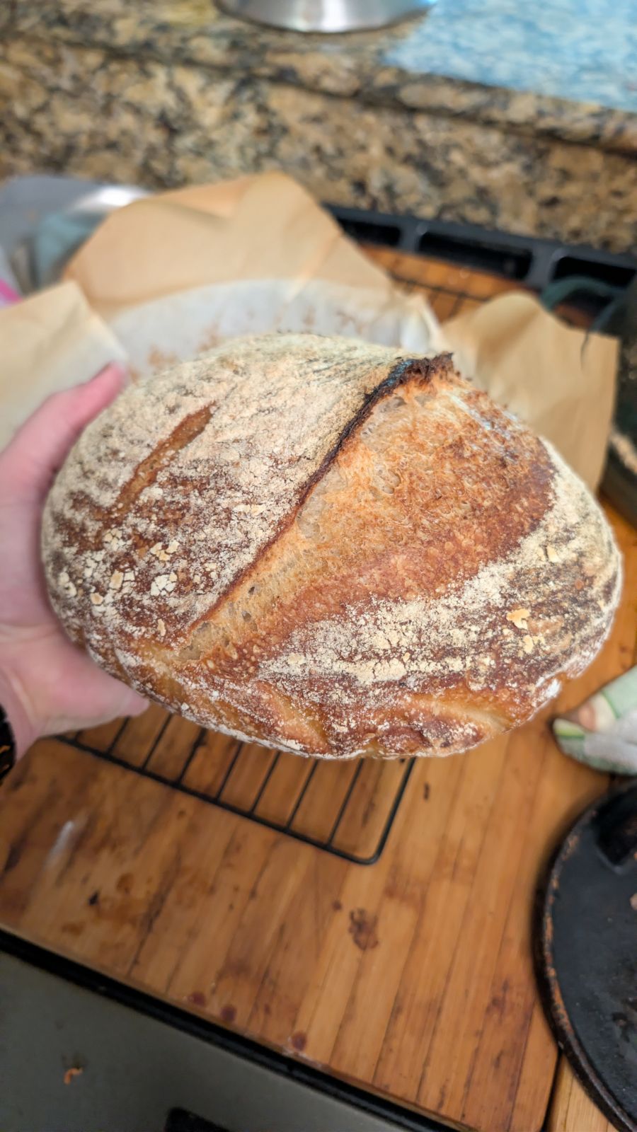 Close detail of the second sourdough boule showing its flour-dusted crust and scoring