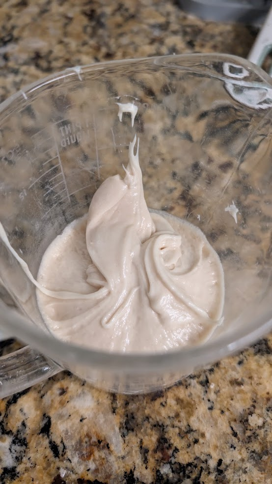 Lievito madre reduced to a sticky, glue-like paste in a glass measuring cup